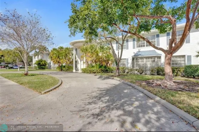 a view of a house with trees in the background