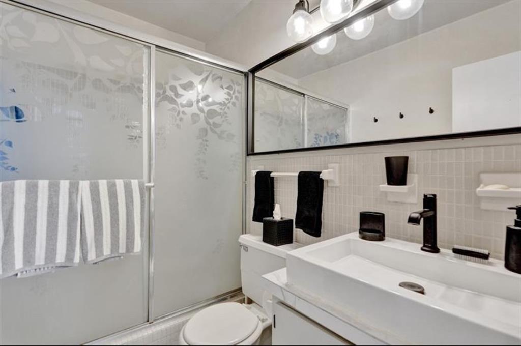 6750 Northeast 21st Road, Unit 123 Fort Lauderdale, FL 33308 - Photo 7 of 12 a bathroom with a sink toilet mirror and vanity