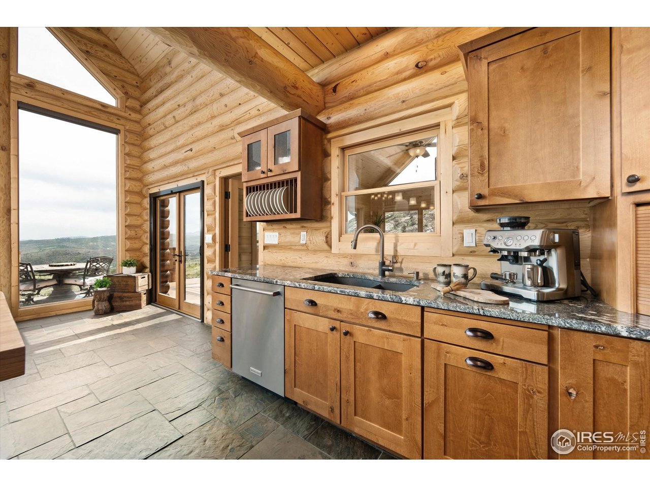 4119 Davis Ranch Road Bellvue, CO 80512 - Photo 14 of 40 a open kitchen with stainless steel appliances granite countertop a stove a sink dishwasher and cabinets with wooden floor