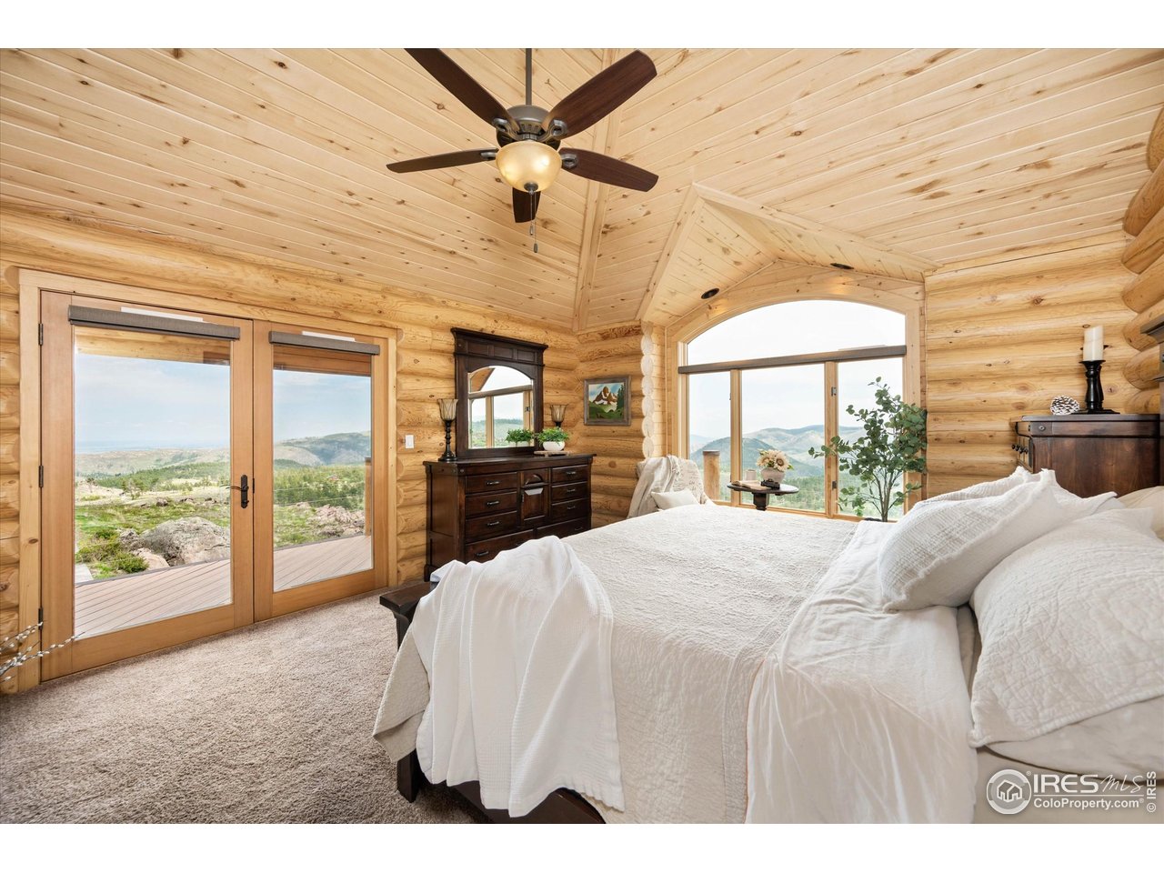 4119 Davis Ranch Road Bellvue, CO 80512 - Photo 18 of 40 a large bedroom with a large bed and a large window