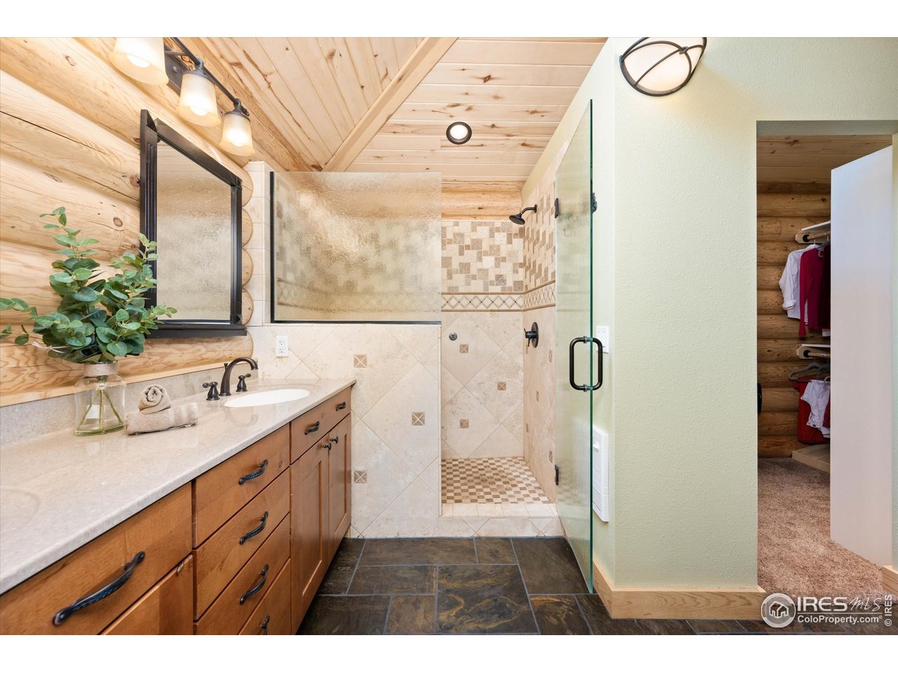4119 Davis Ranch Road Bellvue, CO 80512 - Photo 21 of 40 a bathroom with a double vanity sink mirror and shower