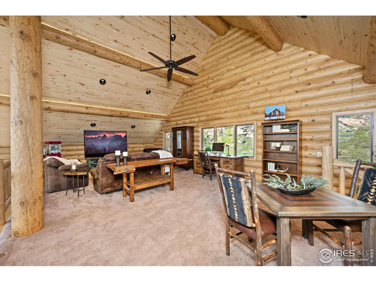 4119 Davis Ranch Road Bellvue, CO 80512 - Photo 22 of 40 a living room with furniture and wooden floor
