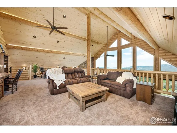 a living room with furniture and a floor to ceiling window