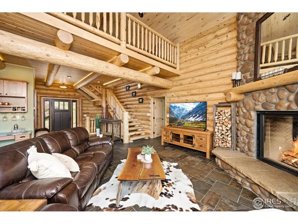 a living room with furniture a flat screen tv and a fireplace