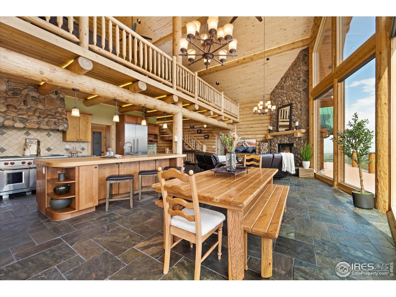 4119 Davis Ranch Road Bellvue, CO 80512 - Photo 10 of 40 a dining hall with stainless steel appliances kitchen island granite countertop a table and chairs