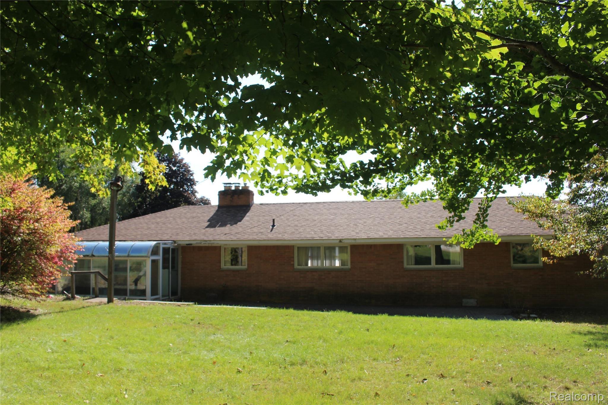 1650 West Predmore Road Oakland, MI 48363 - Photo 3 of 19 beautiful trees, spacious back yard, pleasant sunroom on back of house
