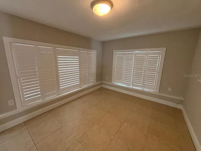 a bathroom with a double vanity sink toilet and mirror