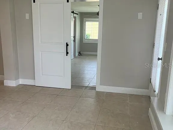 a kitchen with stainless steel appliances granite countertop a refrigerator a sink a stove and a oven