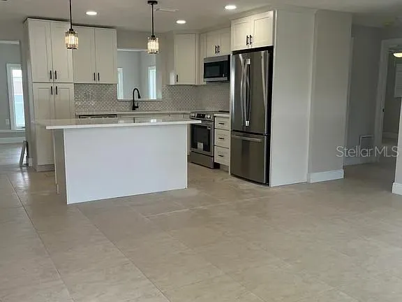 a view of a patio with a table chairs and a backyard