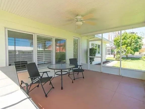 a view of a house with backyard sitting area and garden