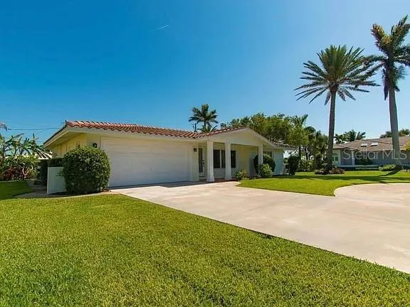 a front view of a house with yard and swimming pool