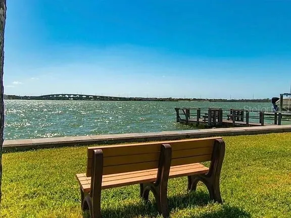 an aerial view of a city with lots of residential buildings ocean and mountain view in back