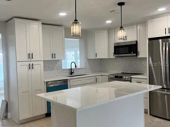 a kitchen with cabinets and white stainless steel appliances