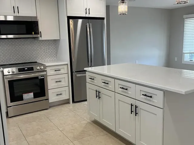 a kitchen with a stove and a microwave