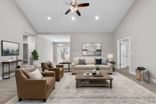 a living room with furniture and a chandelier