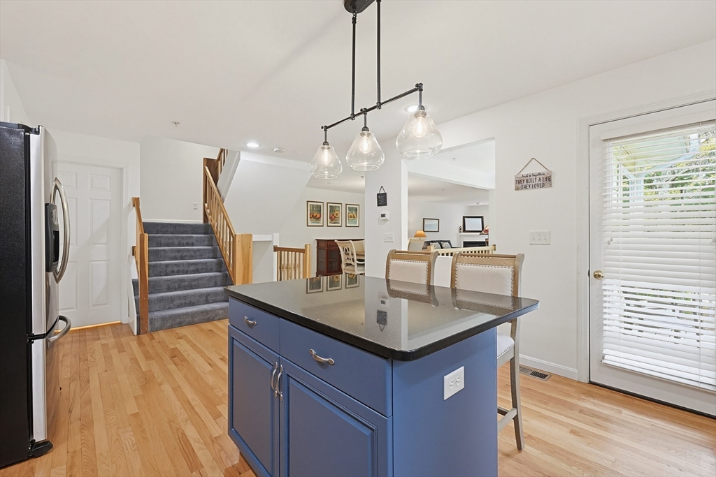 3002 Maple Brook Road, Unit 3002 Bellingham, MA 02019 - Photo 15 of 42 a kitchen with stainless steel appliances granite countertop a sink and a refrigerator