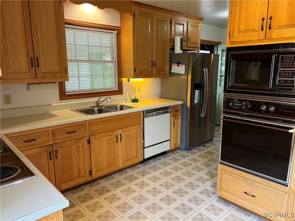 8426 Forge Road Henrico, VA 23228 - Photo 12 of 46 Kitchen featuring black appliances, light countert