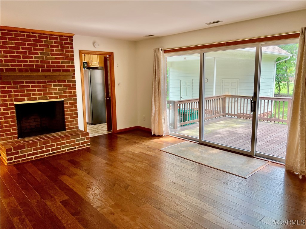 8426 Forge Road Henrico, VA 23228 - Photo 16 of 46 Unfurnished living room featuring wood-type floori