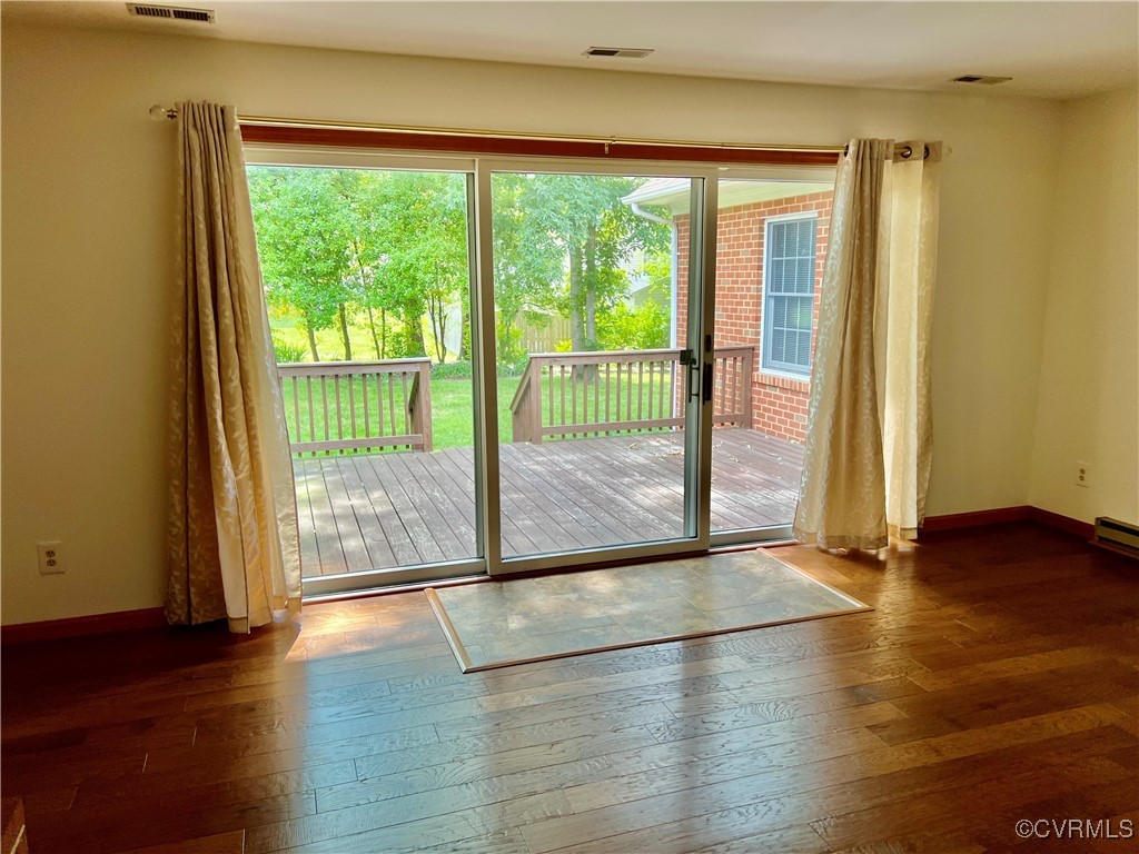 8426 Forge Road Henrico, VA 23228 - Photo 19 of 46 Doorway featuring wood-type flooring and baseboard