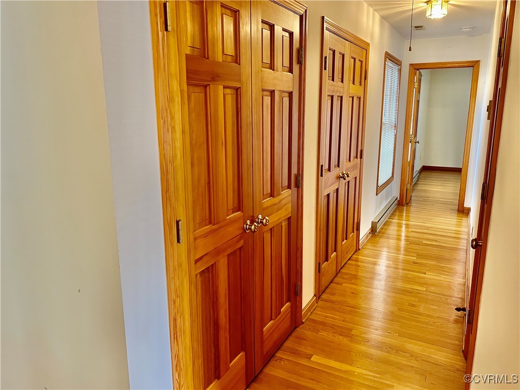 8426 Forge Road Henrico, VA 23228 - Photo 25 of 46 Hallway with light wood-style floors and a baseboa