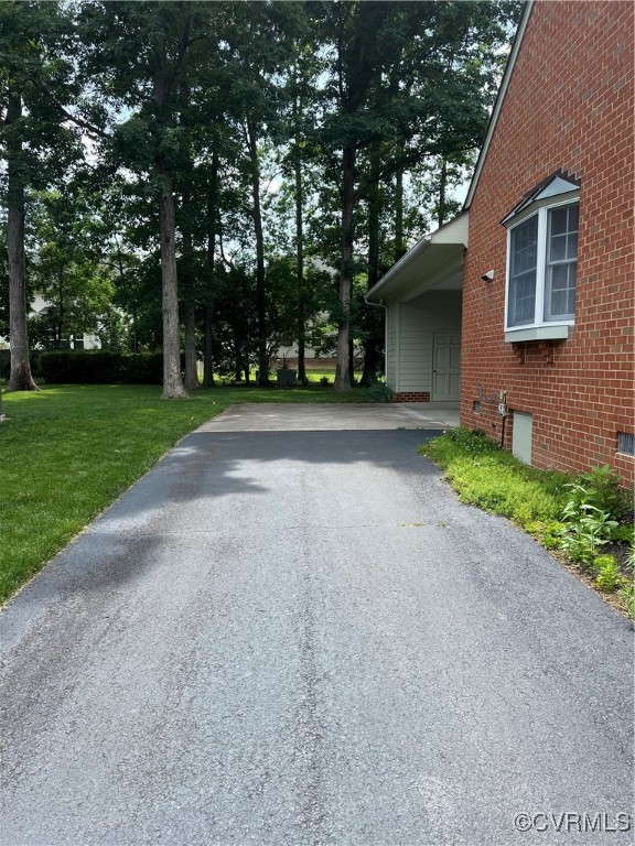 8426 Forge Road Henrico, VA 23228 - Photo 3 of 46 View of side of home with brick siding, asphalt dr