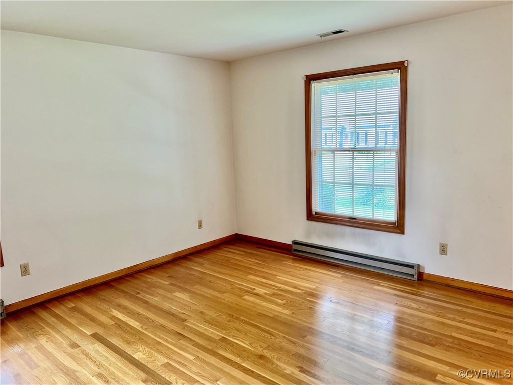 8426 Forge Road Henrico, VA 23228 - Photo 34 of 46 Spare room featuring baseboard heating and light w