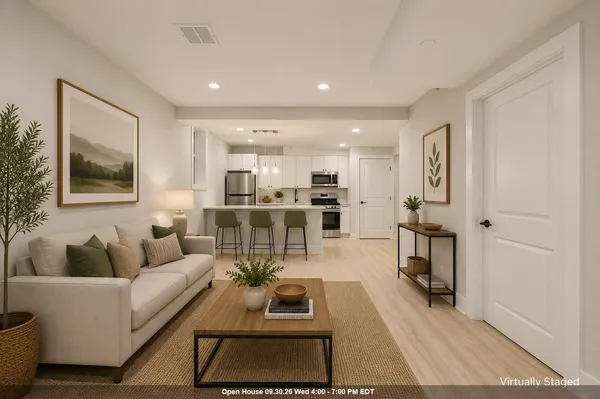 a living room with furniture and a potted plant