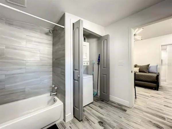 a bathroom with a tub shower and a sink