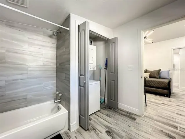 a bathroom with a tub shower and a sink