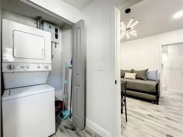 a living room with furniture and a mirror