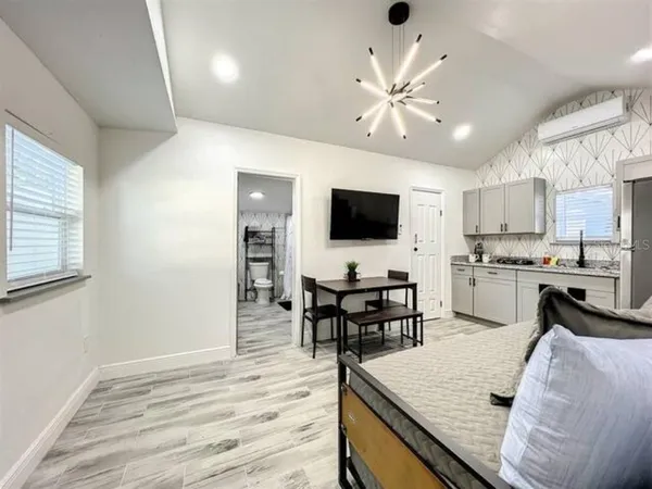 a kitchen with a table chairs microwave and cabinets