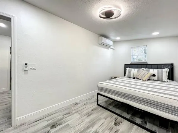 a bedroom with bed and a window