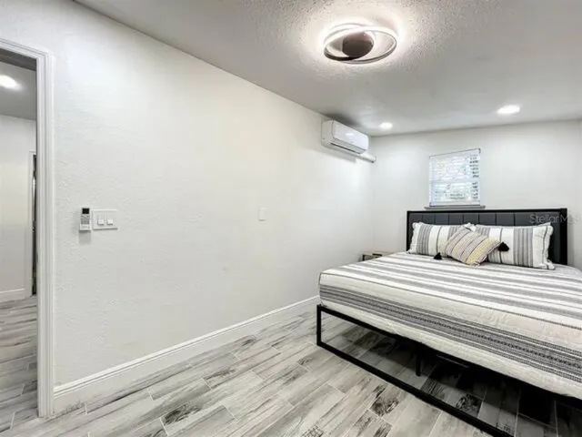 a bedroom with bed and a window