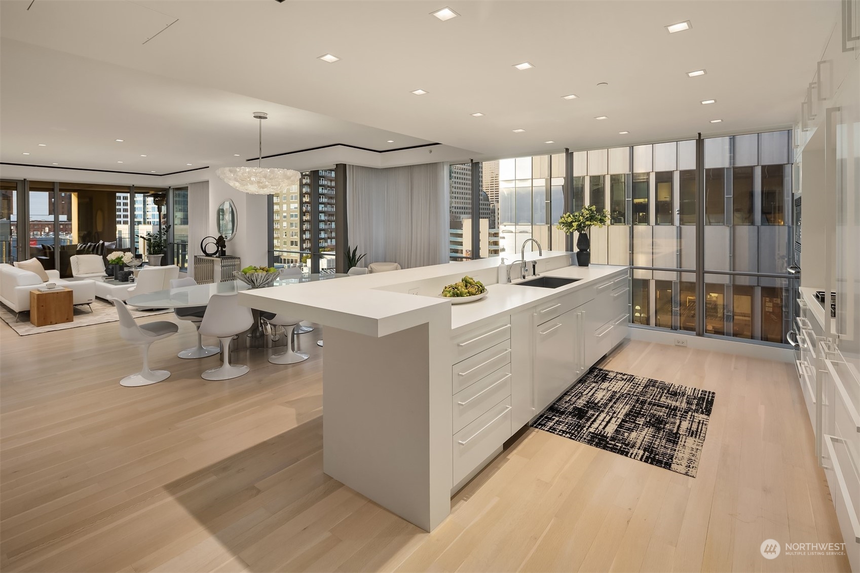 99 Union Street, Unit 1104 Seattle, WA 98101 - Photo 12 of 38 a large dining hall with stainless steel appliances granite countertop a stove and a sink with cabinets