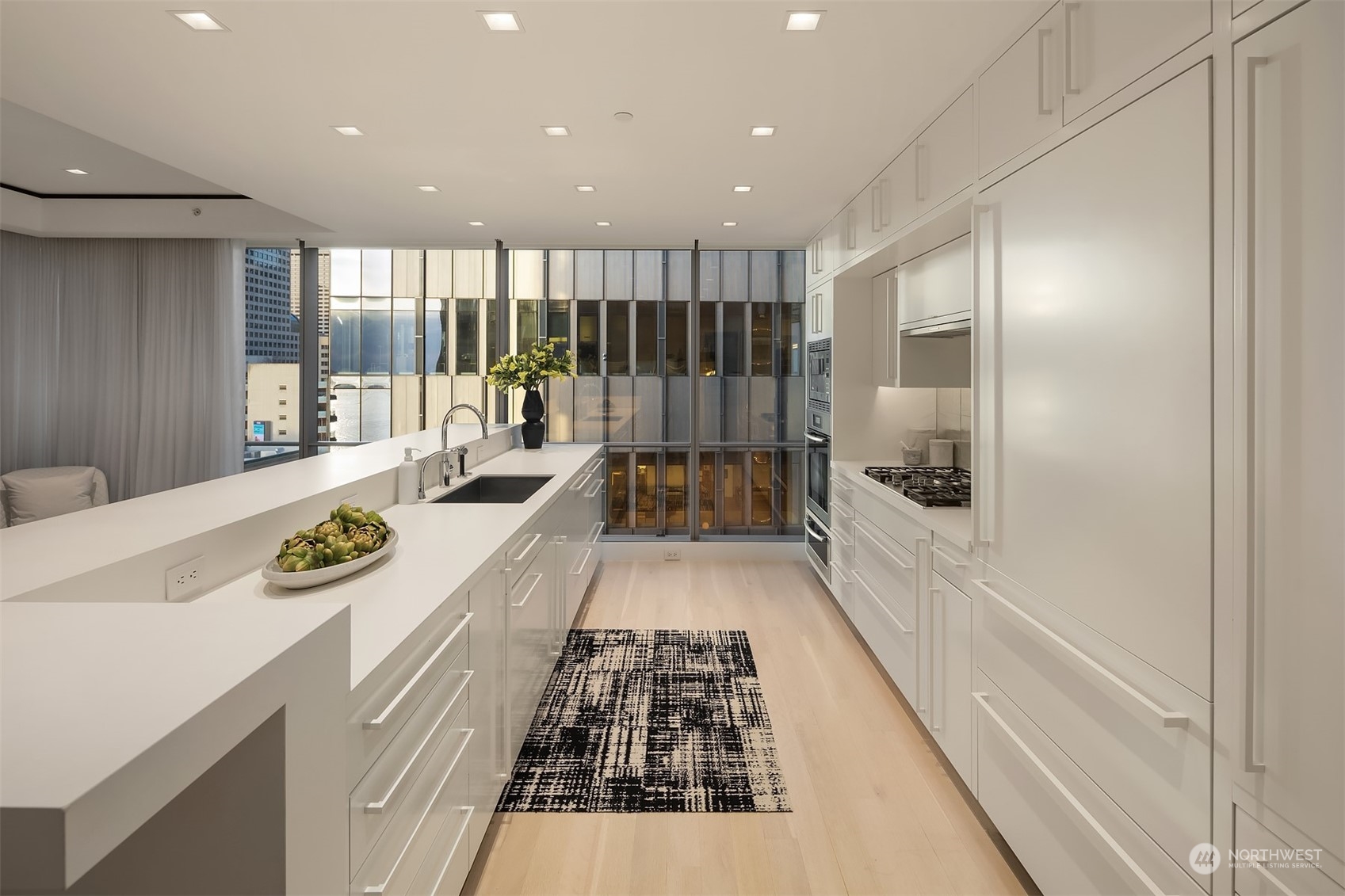 99 Union Street, Unit 1104 Seattle, WA 98101 - Photo 13 of 38 a large white kitchen with a large window