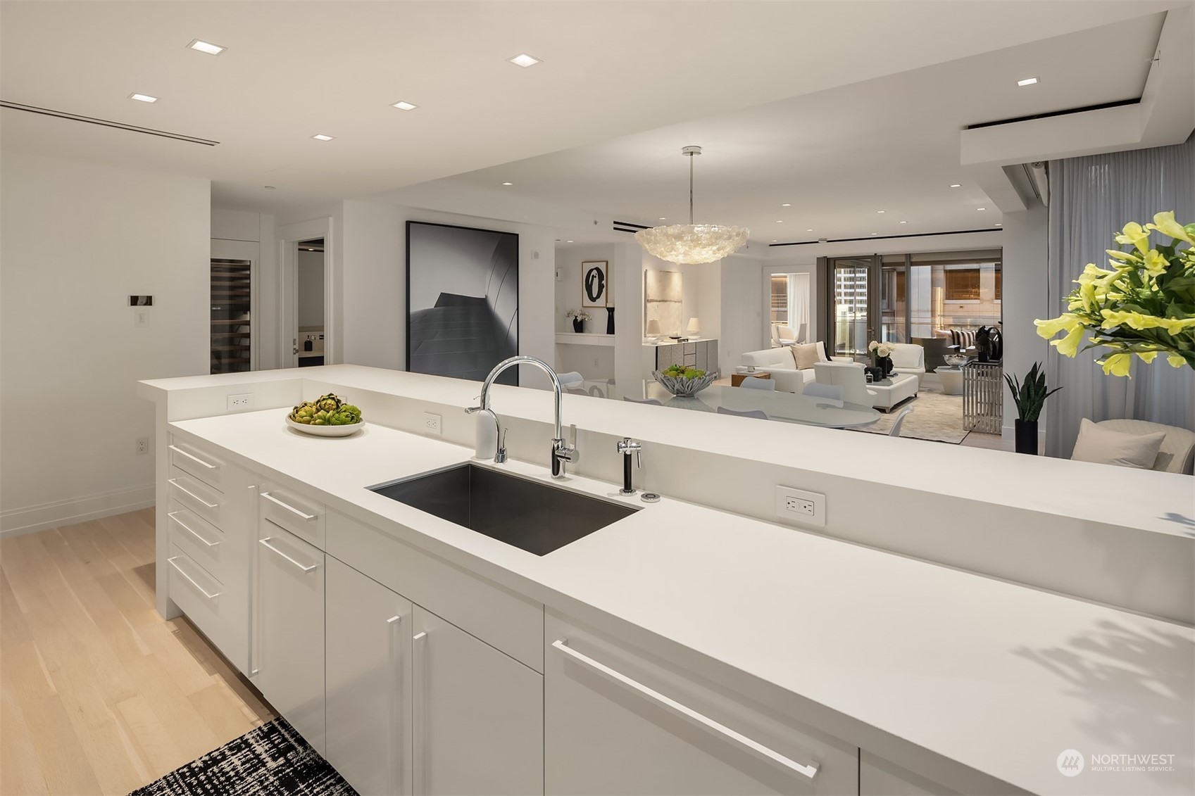 99 Union Street, Unit 1104 Seattle, WA 98101 - Photo 14 of 38 a large white kitchen with a sink and cabinets