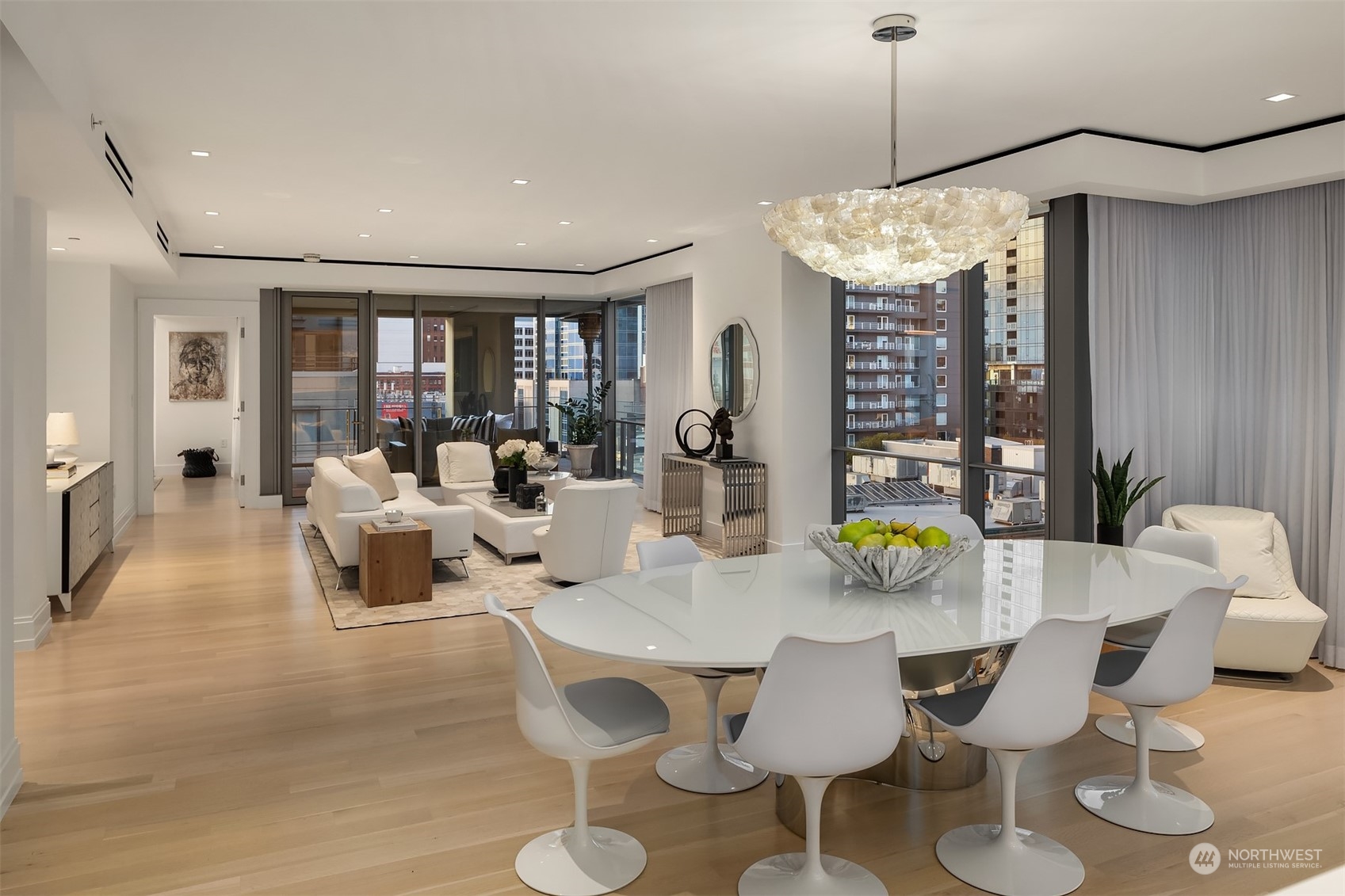 99 Union Street, Unit 1104 Seattle, WA 98101 - Photo 17 of 38 a view of a dining room with furniture a chandelier and wooden floor