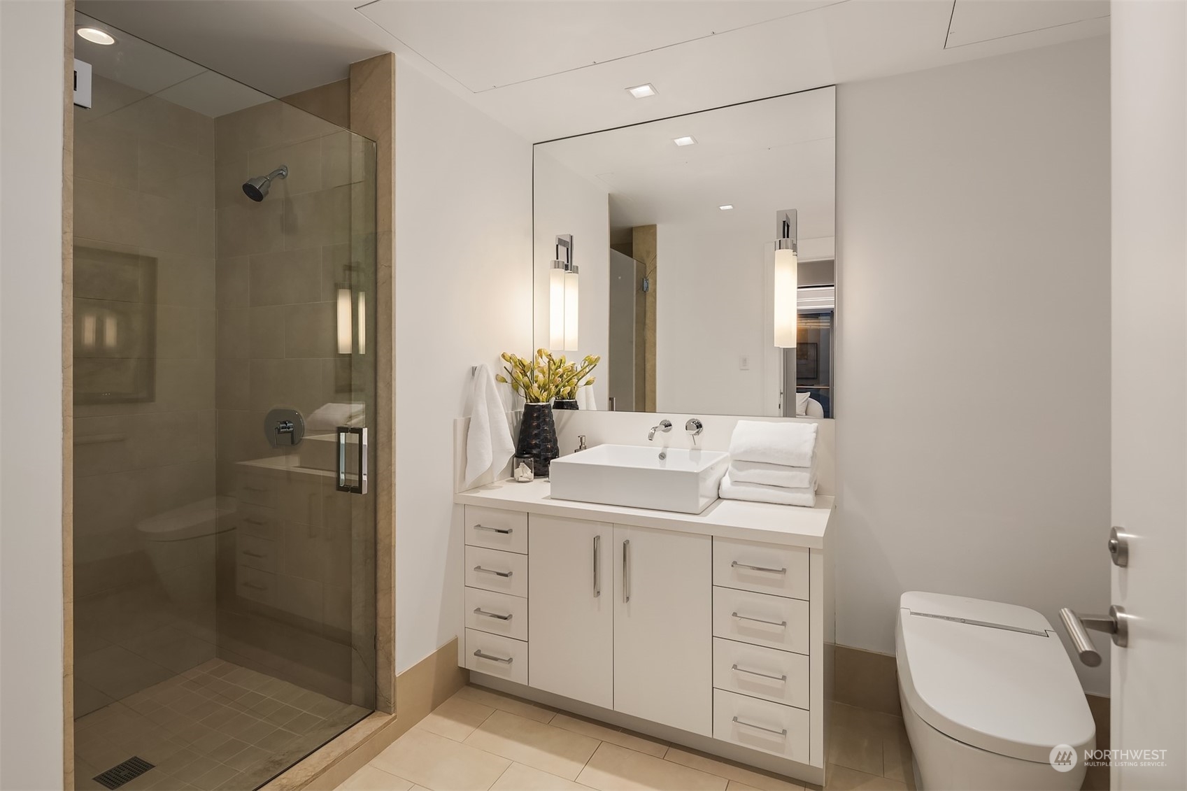 99 Union Street, Unit 1104 Seattle, WA 98101 - Photo 27 of 38 a bathroom with a granite countertop sink toilet mirror and shower