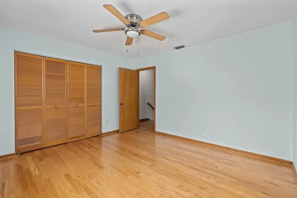 an empty room with a empty space and a ceiling fan