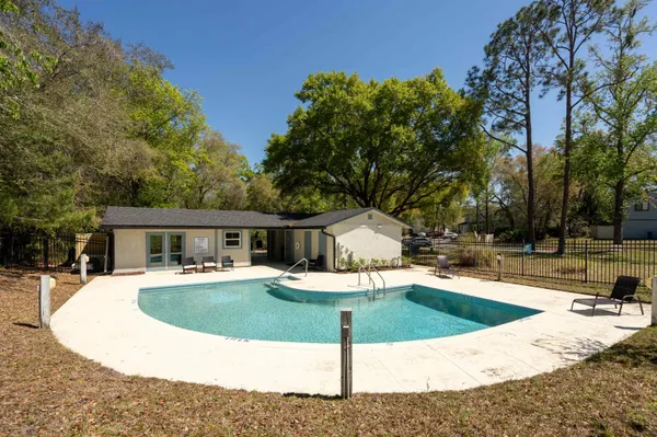 a view of a house with swimming pool and sitting area