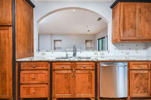 a kitchen with granite countertop cabinets and window