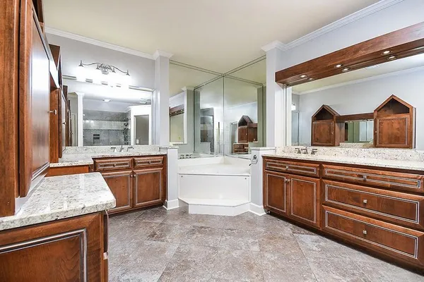 a spacious bathroom with a granite countertop sink and a large mirror