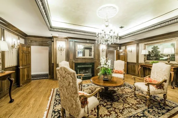 a living room with fireplace furniture and a chandelier