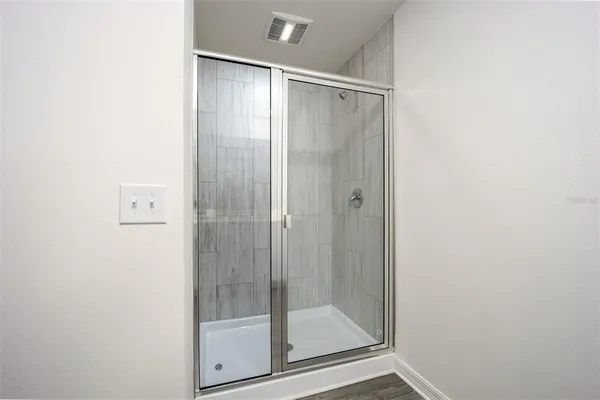 a bathroom with a glass shower door
