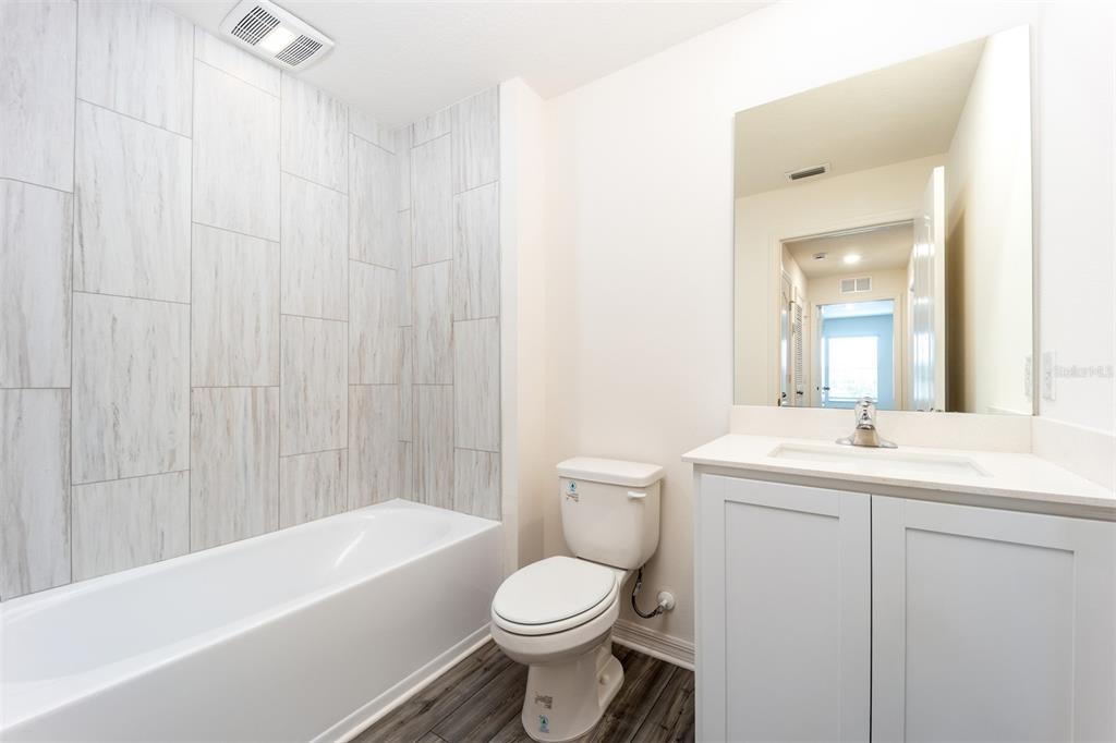691 Poppy Lane Dundee, FL 33838 - Photo 15 of 16 a bathroom with a toilet a sink and a bathtub