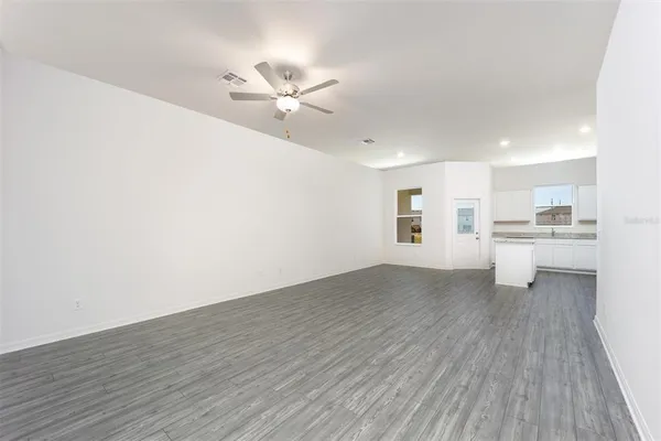 a view of a kitchen with a sink and wooden floor