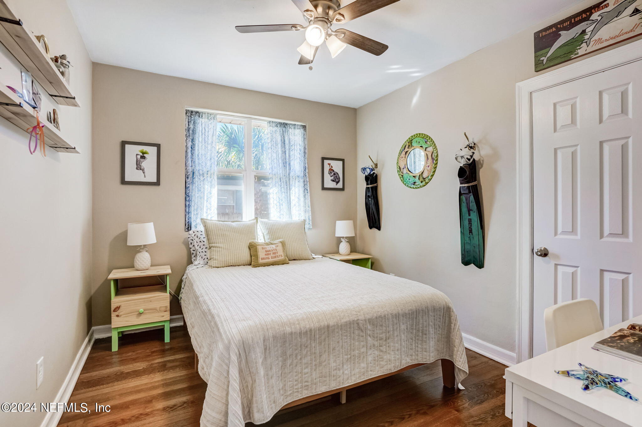 1435 Monticello Road Jacksonville, FL 32207 - Photo 19 of 33 a bedroom with a bed a chandelier and a window