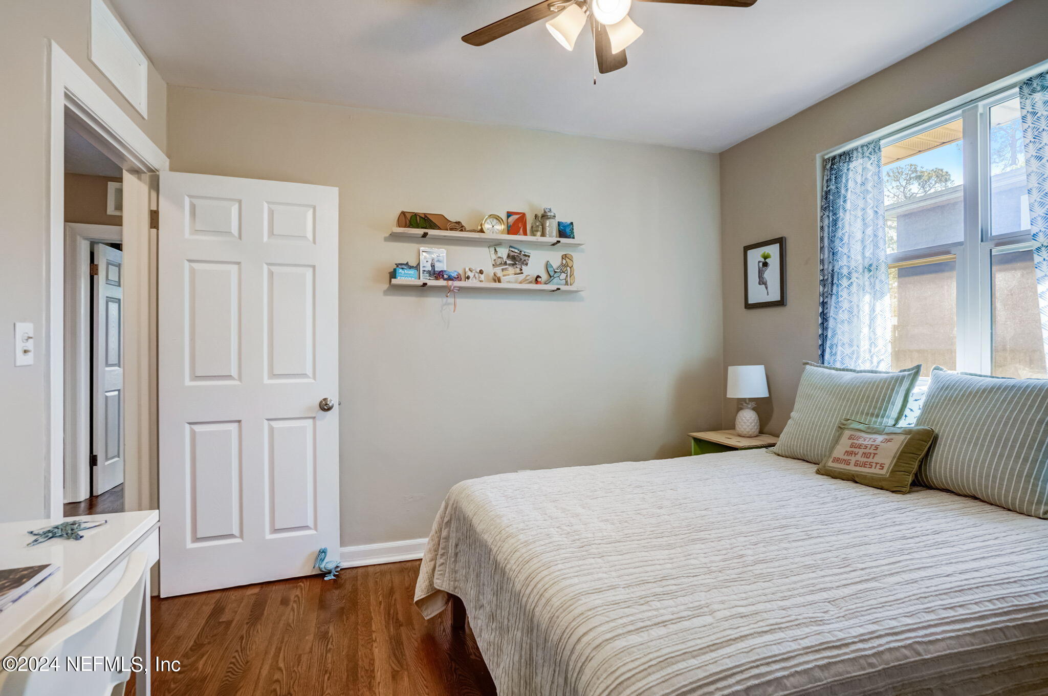 1435 Monticello Road Jacksonville, FL 32207 - Photo 20 of 33 a bedroom with a large bed and a chandelier