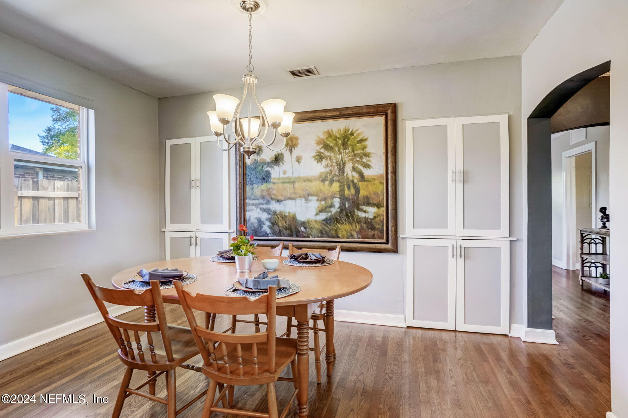 1435 Monticello Road Jacksonville, FL 32207 - Photo 7 of 33 a dining room with furniture a chandelier and wooden floor