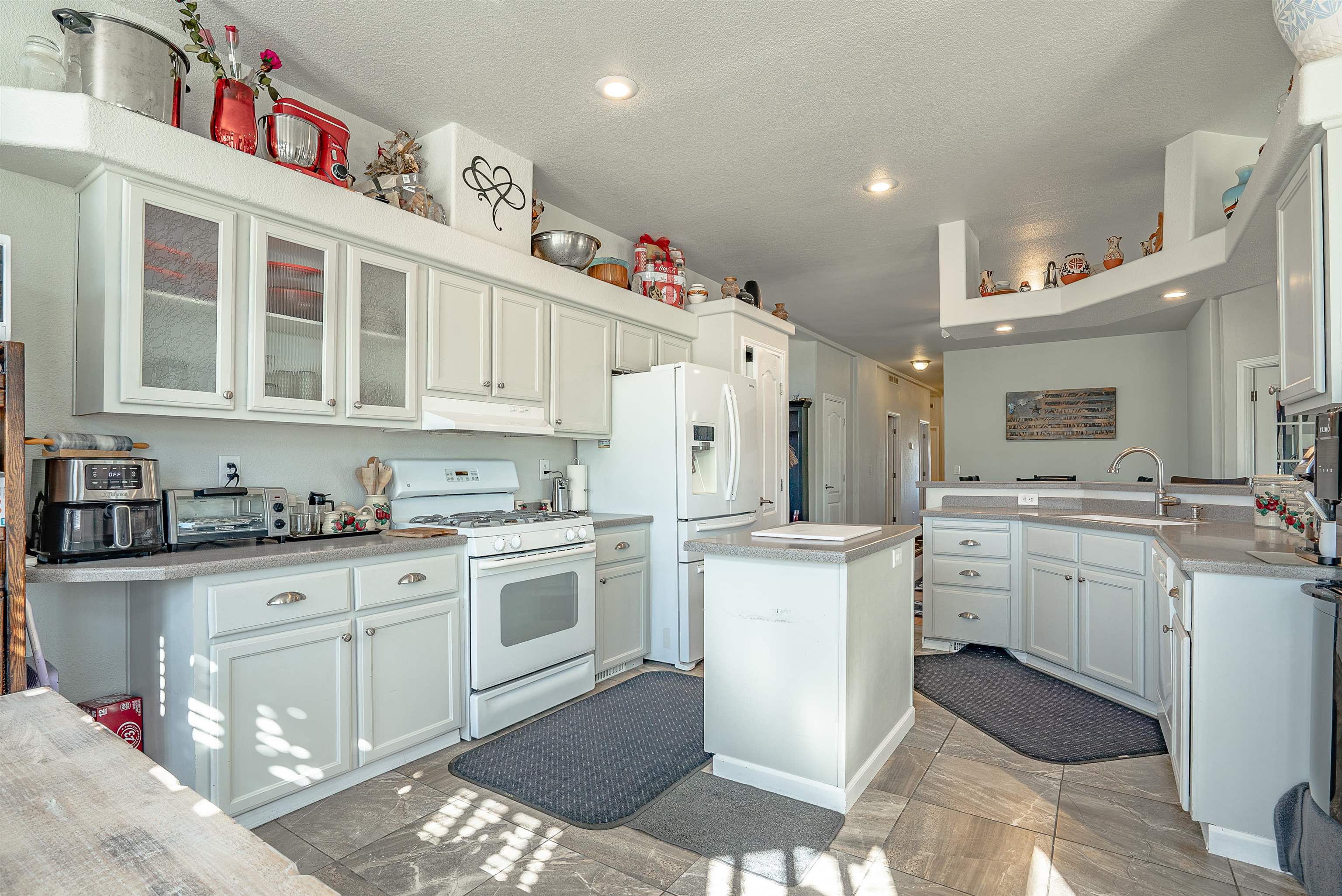 714-100 Sears Road Janesville, CA 96114 - Photo 14 of 35 a kitchen with white cabinets a sink stove and refrigerator